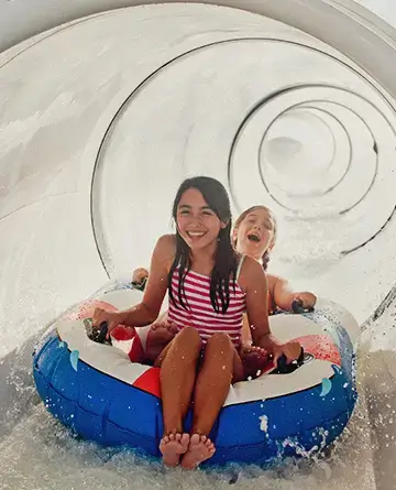 Girls enjoying a water slide on a cruise ship